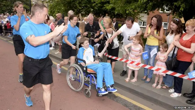 Sam McAleer with the Queen's Baton in Rutherglen