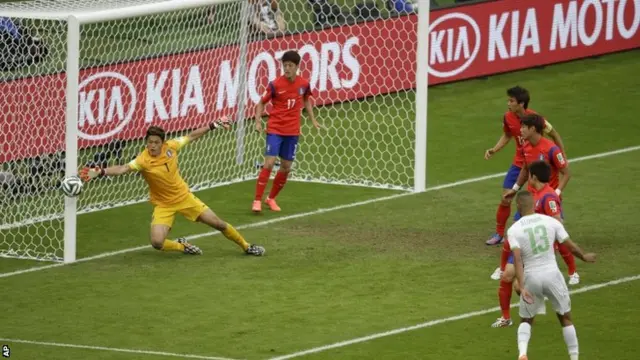 Algeria's Islam Slimani, No 13 right, heads the ball past the goal