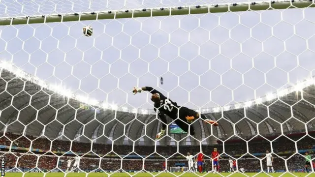 Algeria's goalkeeper Rais Mbolhi saves a shot by South Korea's Ki Sung-yueng