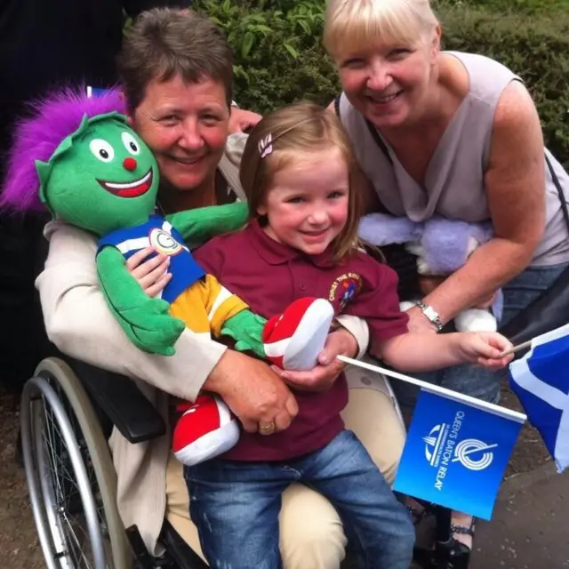 Young girl poses with her two grandmas