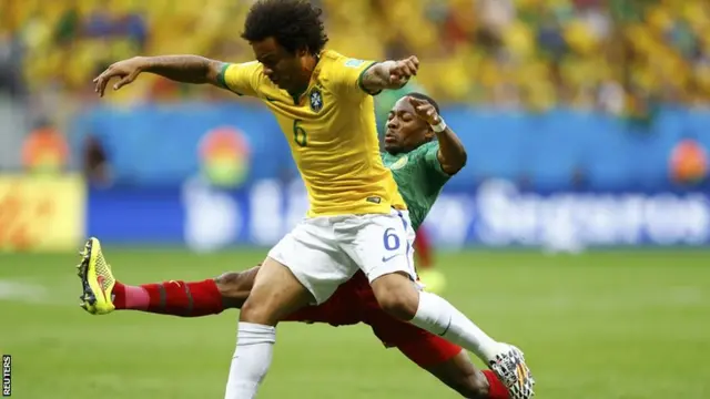 Eyong Enoh fouls Brazil's Marcello