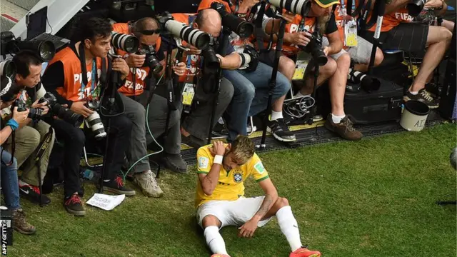 Neymar checks the damage after he was forced to the ground in the match against Cameroon