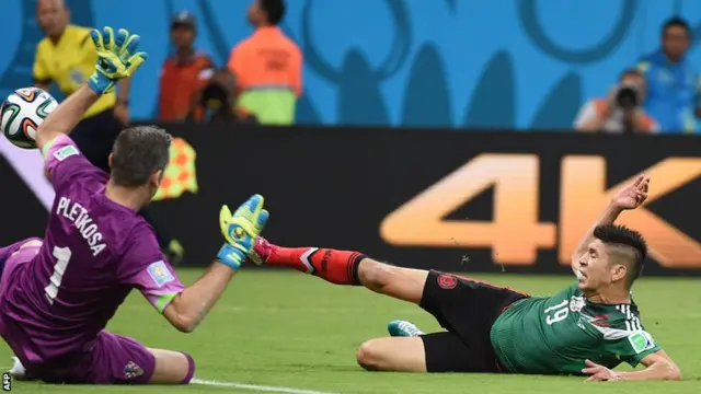 Oribe Peralta slips as he aims to shoot for Mexico against Croatia