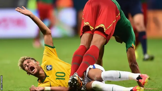 Neymar is hurt after being tackled by a Cameroon defender