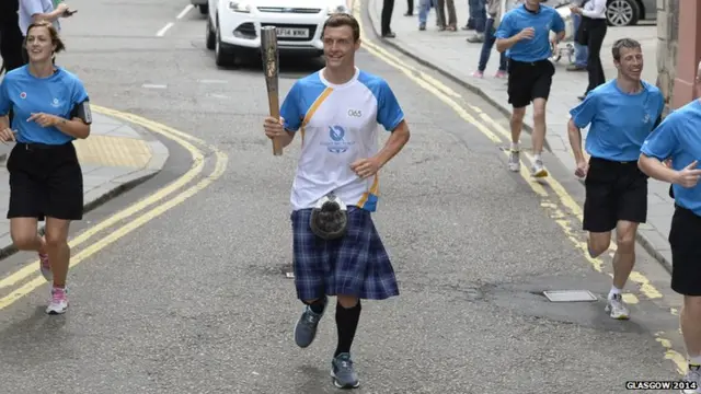 Jak Scott carries Queen's baton