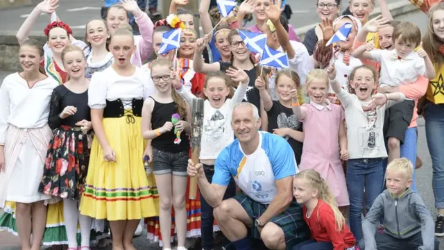 Alan Keith with the baton and supporters in Grangemouth