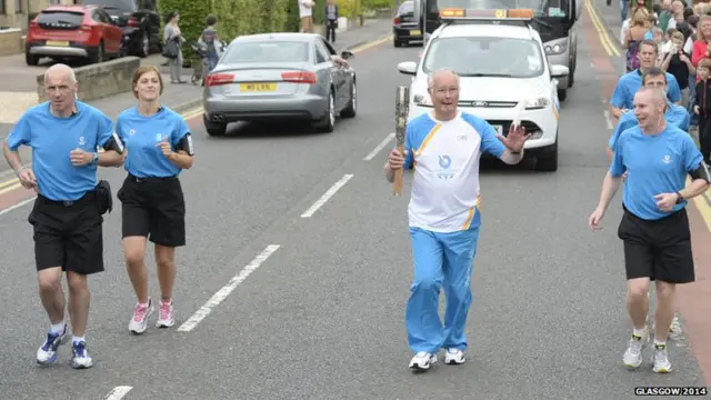 Bill Wintrup runs with the baton