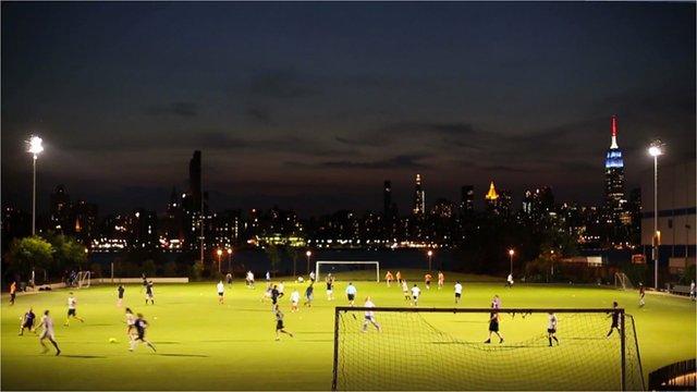 A football field in Brooklyn with Manhattan skyline behind