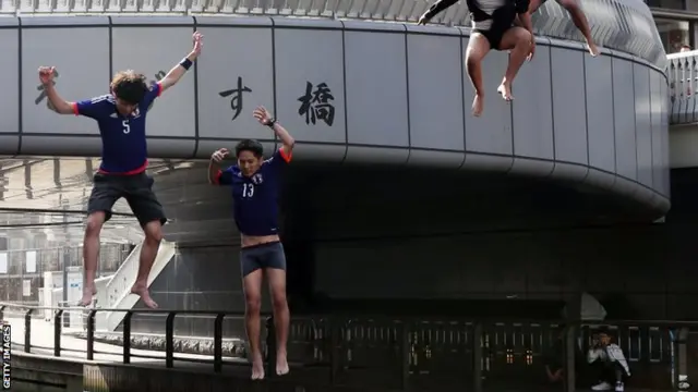 Japan fans jump into river