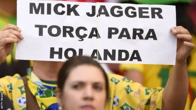 Brazil fans hold up Mick Jagger sign at World Cup