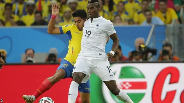 France's Paul Pogba, right, is challenged by Ecuador's Cristhian Noboa