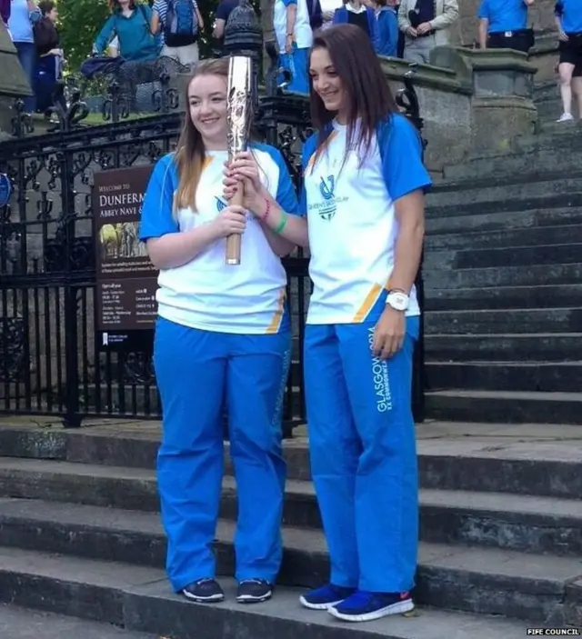 Baton bearers on steps of abbey