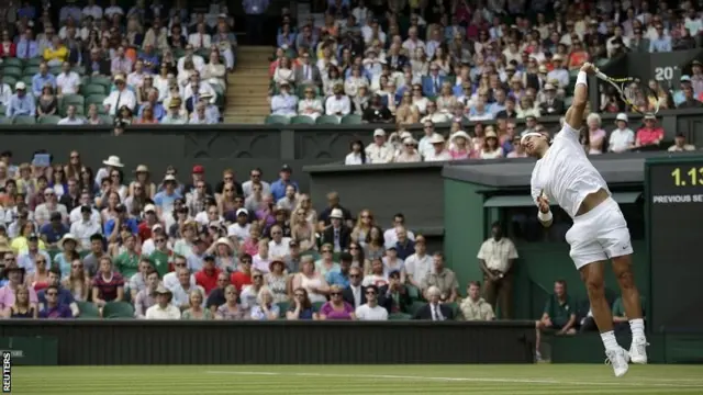 Rafael Nadal serves