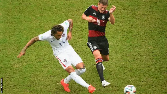 Jermaine Jones of the USA fights it out with Germany's Toni Kroos for the ball