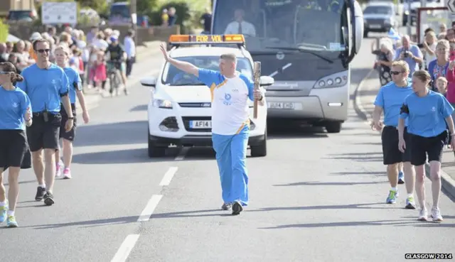 Alexander Anderson carries the Glasgow 2014 Queen's Baton through Anstruther in Fife