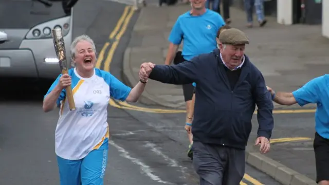 Jean Stevenson runs with the baton