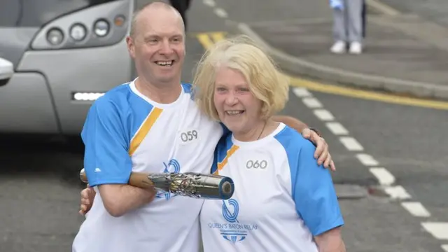 Doug McIntosh passes the baton to Pat Thomson