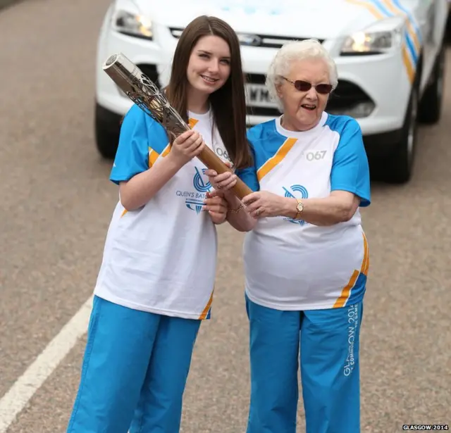 Margaret Walker hands the baton to Emma Reid