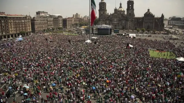 Mexico soccer fans watch the game in Mexico City's main square, the Zocalo