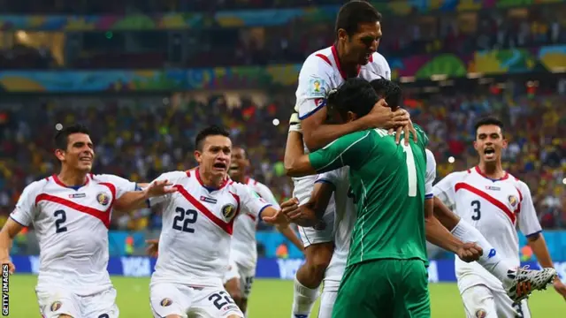 Costa Rica's Keylor Navas is mobbed by his team-mates