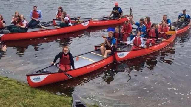 Baton in flotilla of canoes