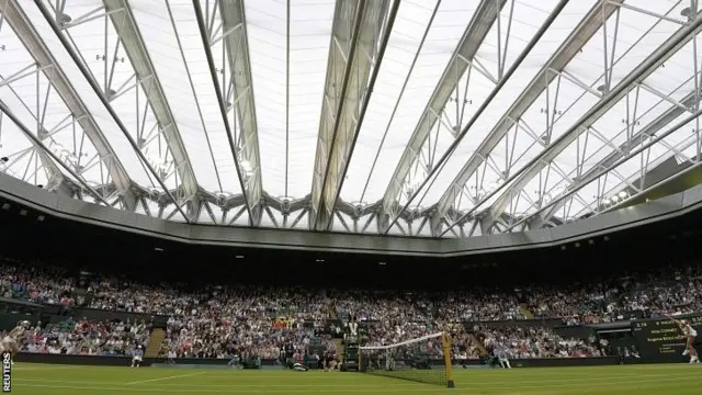 Eugenie Bouchard serves under the Centre Court roof