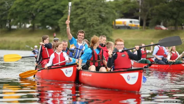 Tim Baillie on the River Dee with the baton