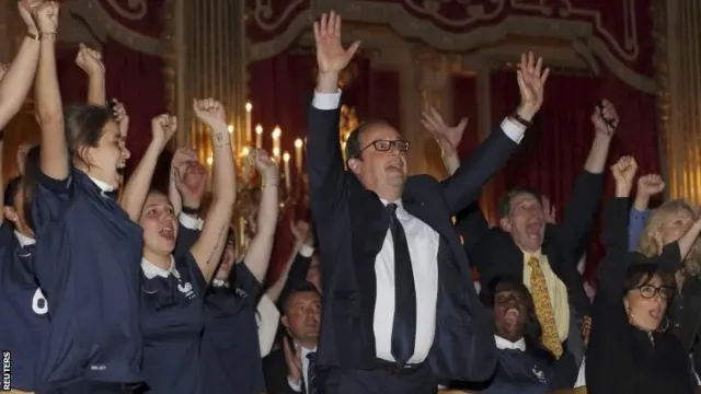 French President Francois Hollande (C) reacts as France team scores a goal against Nigeria in their 2014 World Cup