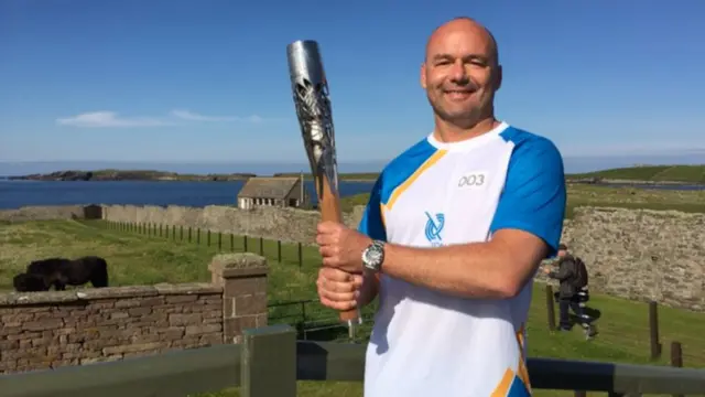 Darren Hall holds the baton in Sumburgh