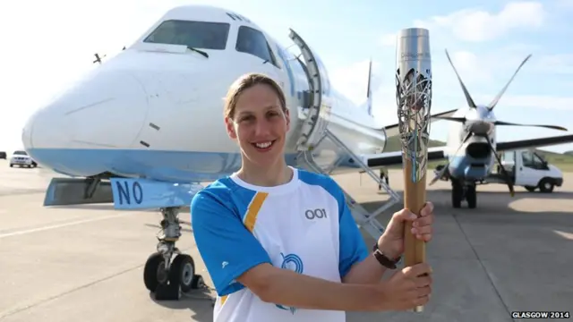 Lynsey Henderson carries the Glasgow 2014 Queen's Baton through Sumburgh on the Shetland Islands