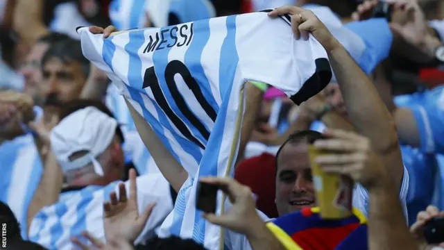 Argentina fans hold up a Lionel Messi shirt at the 2014 World Cup