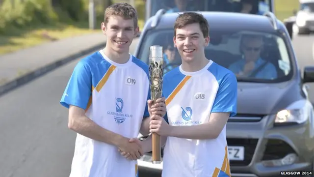 Jarryd Jamieson hands the baton to Tom Jamieson as the relay travels through Sandwick.