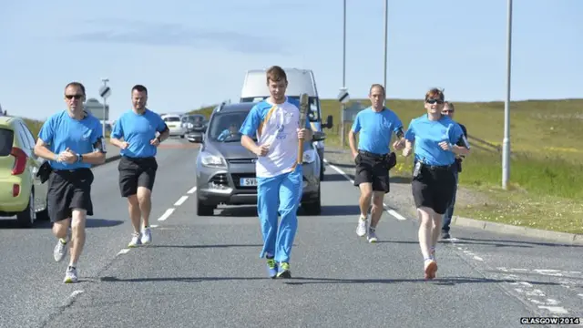 Haydn Thomason looking great as carries the baton in Lerwick.