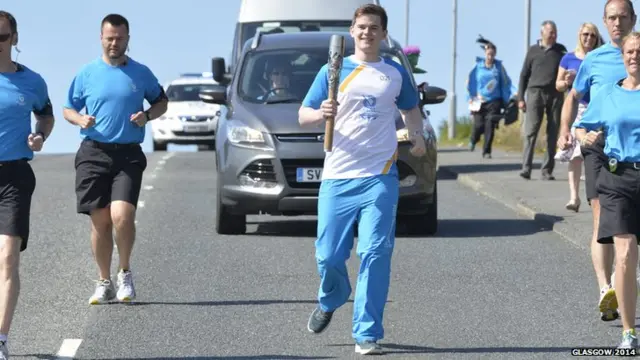 Kristoffer Thomason proudly runs with the baton in Lerwick.