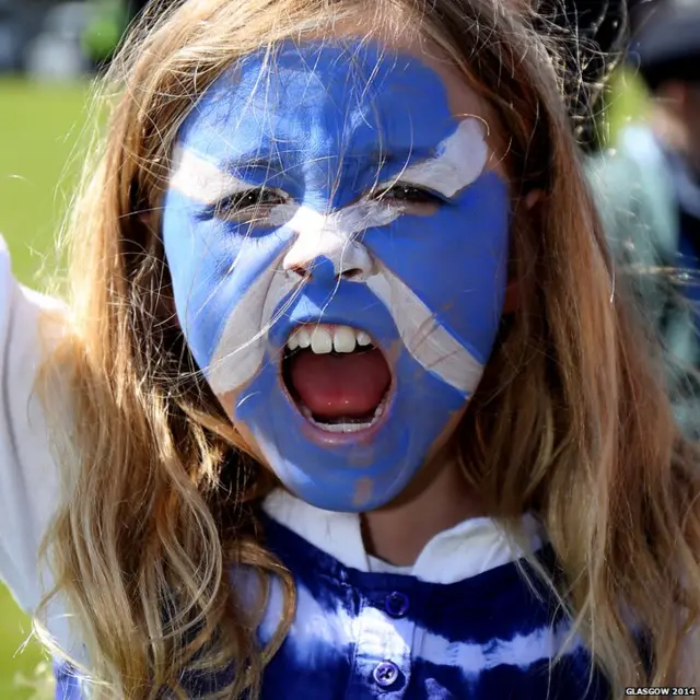 Shouting young girl with Scottish flag painted on her face