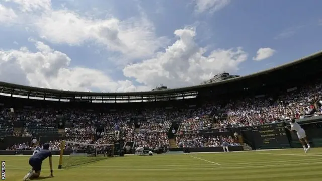 Roger Federer serves