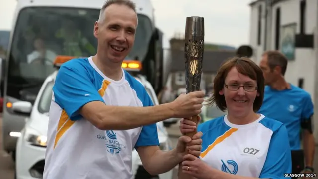 Harry Gordon hands baton to Anne Thomson