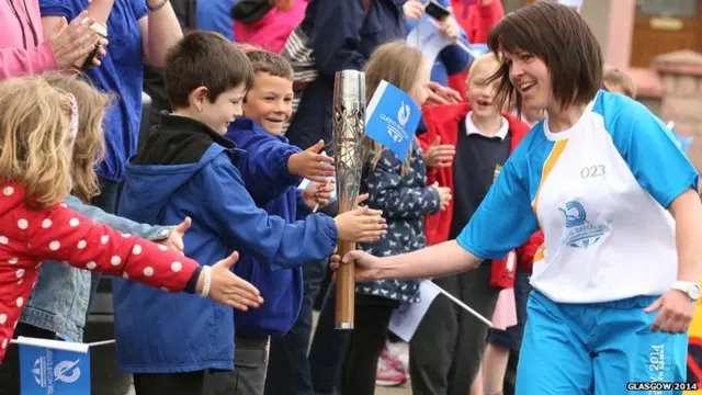 Kim Paterson allowing children to touch baton