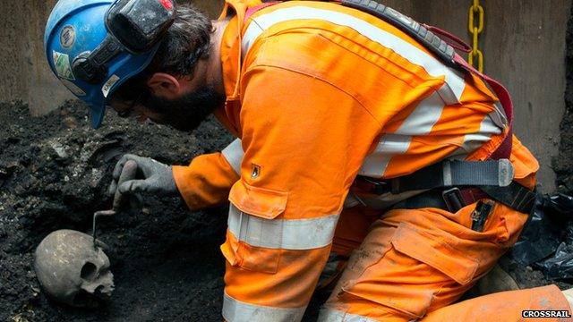 A Crossrail worker excavates a skeleton