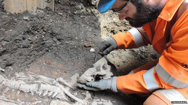 A Crossrail worker excavates a skeleton