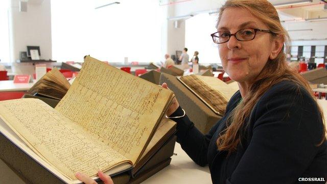 A volunteer searches through parish records