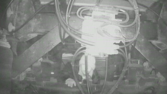 Stowaway climbing under a lorry at Calais