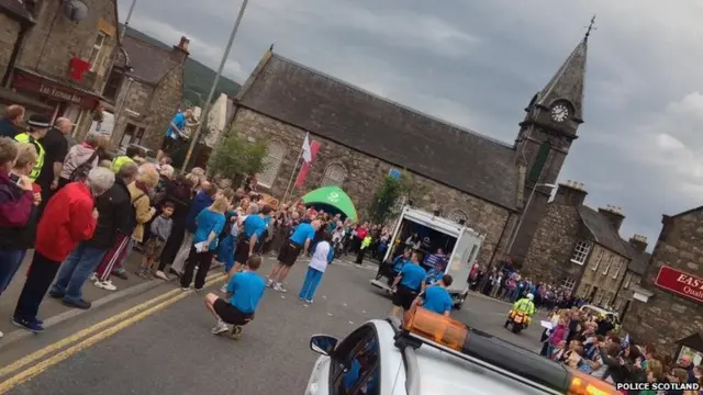 Crowds in Rothes centre. Horizon in picture is at an extreme angle.