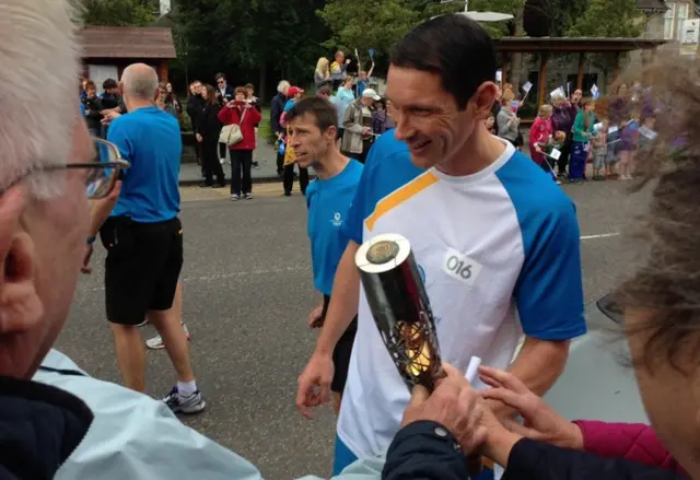 Ronald Ross allowing spectators to touch baton