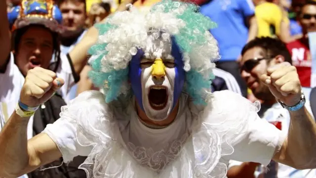 An Argentina fan cheers his team on