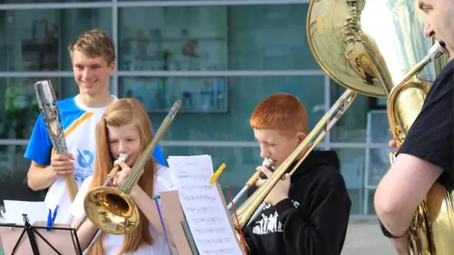 Cameron Milne with a brass band