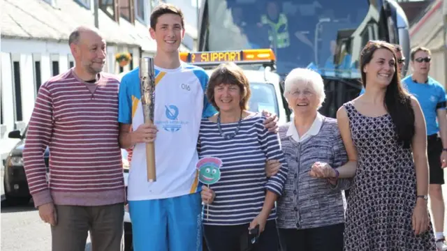 Euan Woodley with the baton