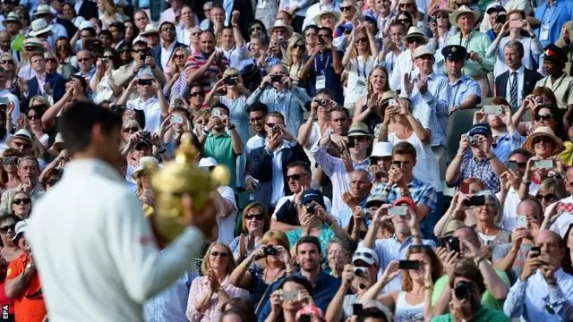 Novak Djokovic shows off the trophy