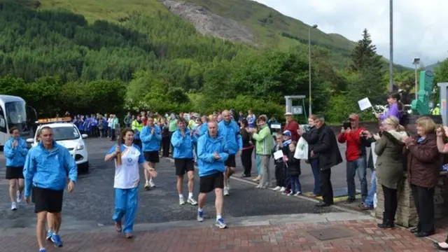 Diane Mailer carries Queen's Baton through Tyndrum