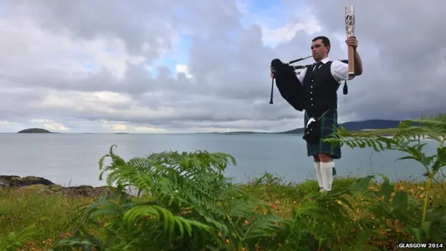 Lone piper welcomes the baton to South Uist.